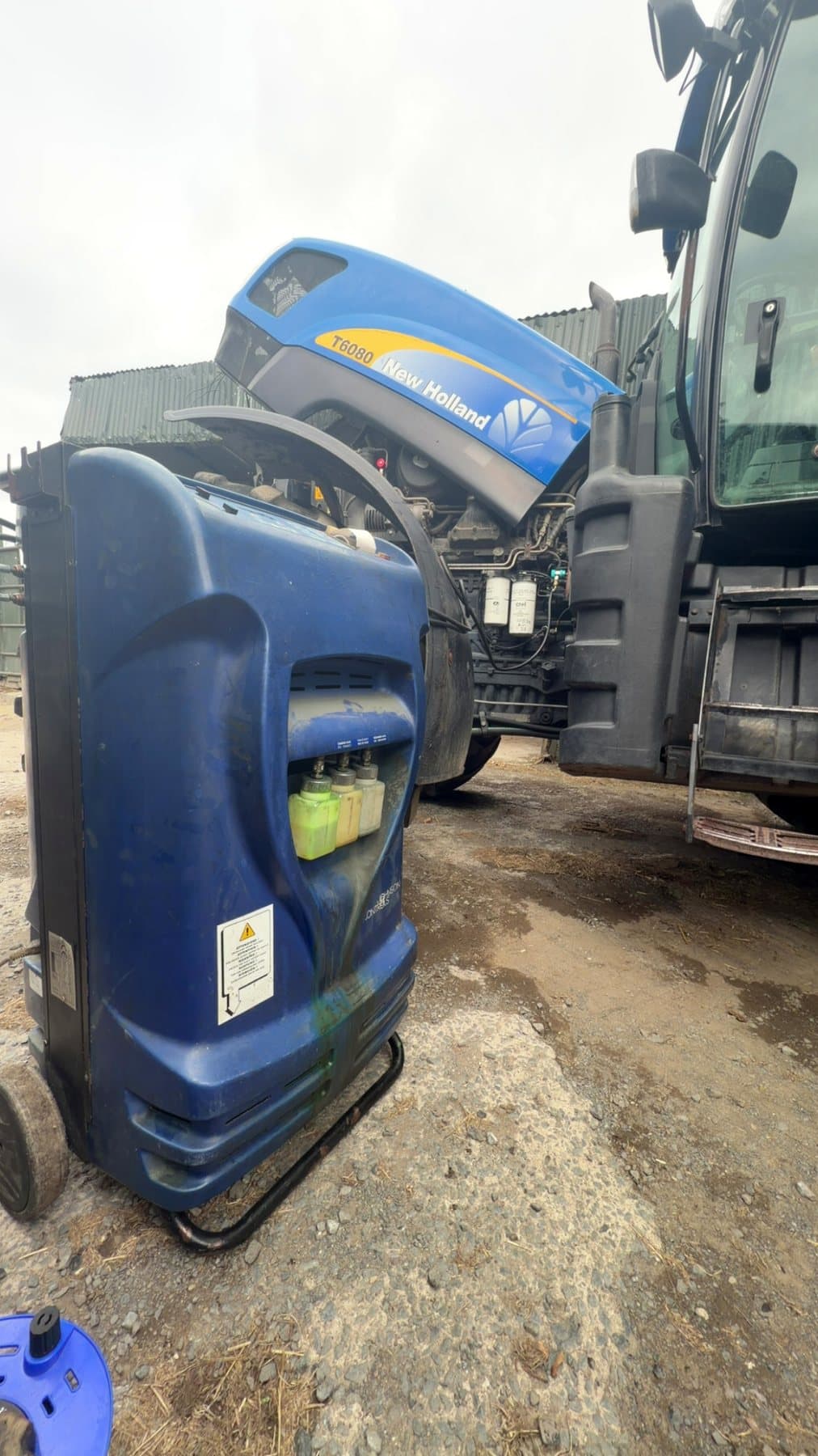 Air conditioning service machine connected to a New Holland tractor